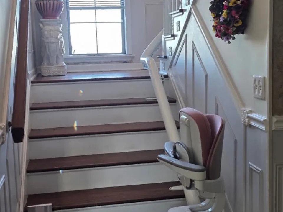 A curved stairlift on a turning staircase in a customer's hallway