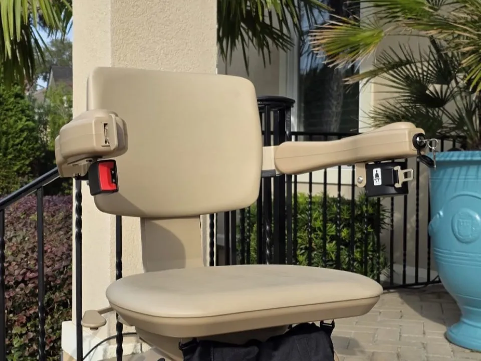 An outdoor stairlift fitted on brick steps at a customer's front door